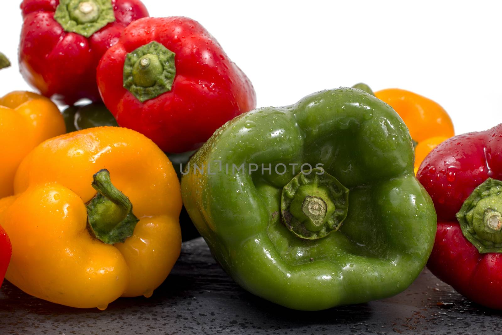 colorful bell peppers on a black stone of schist.