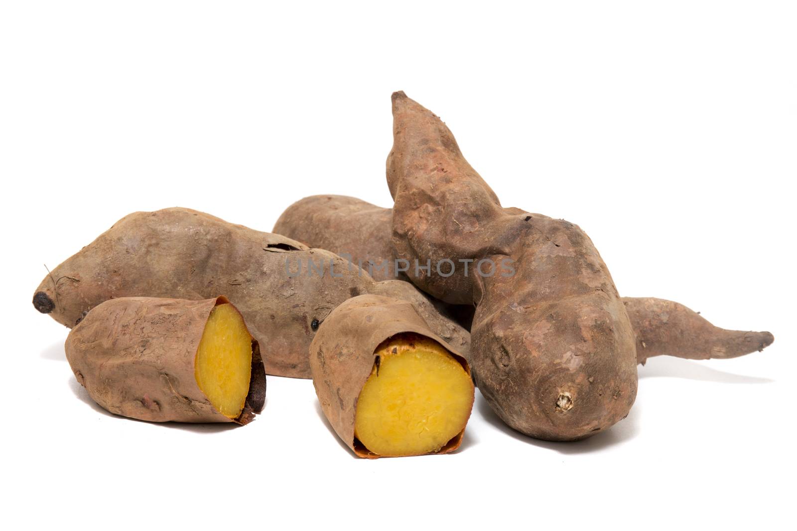 Cooked oven sweet potatoes isolated on a white background.
