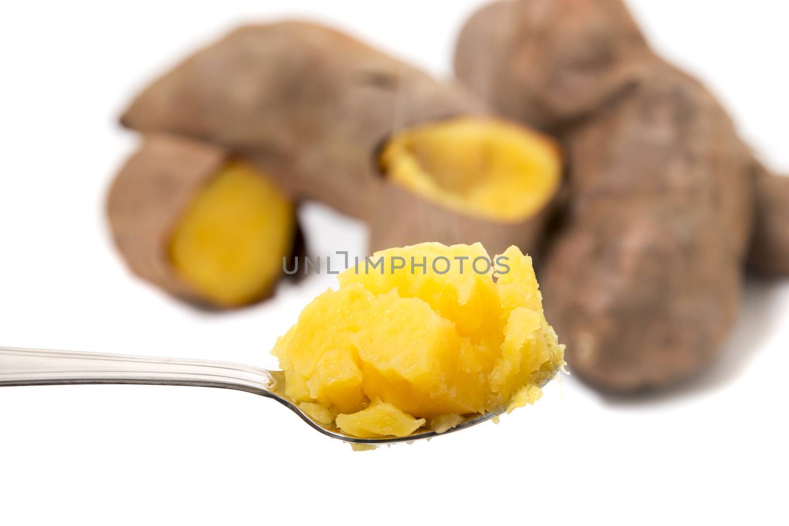 Cooked oven sweet potatoes isolated on a white background.