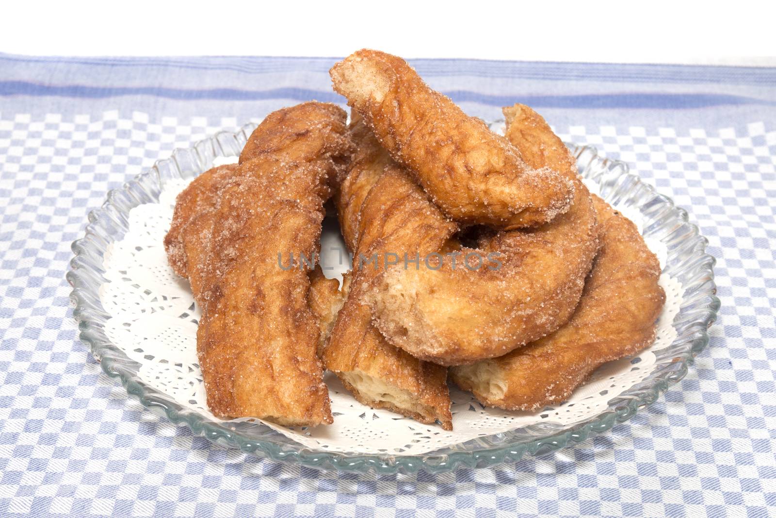 Portuguese Farturas or Spanish Churros, Fried dough sticks on a table cloth.