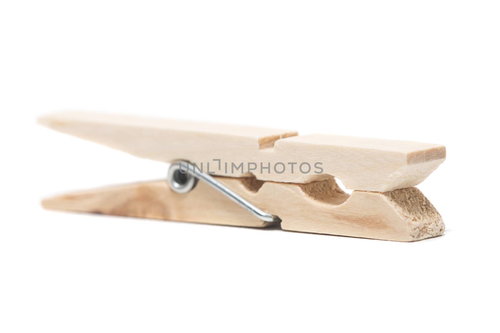 One wooden clothing peg isolated on a white background.