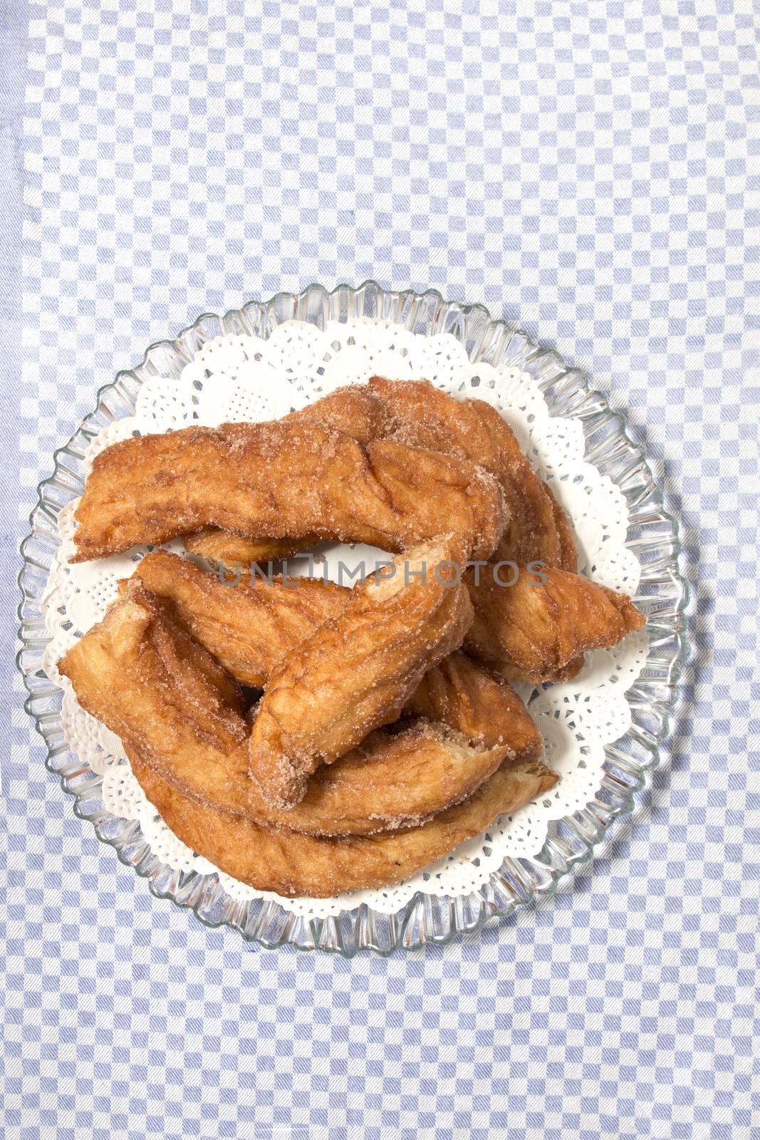 Portuguese Farturas or Spanish Churros, Fried dough sticks on a table cloth.