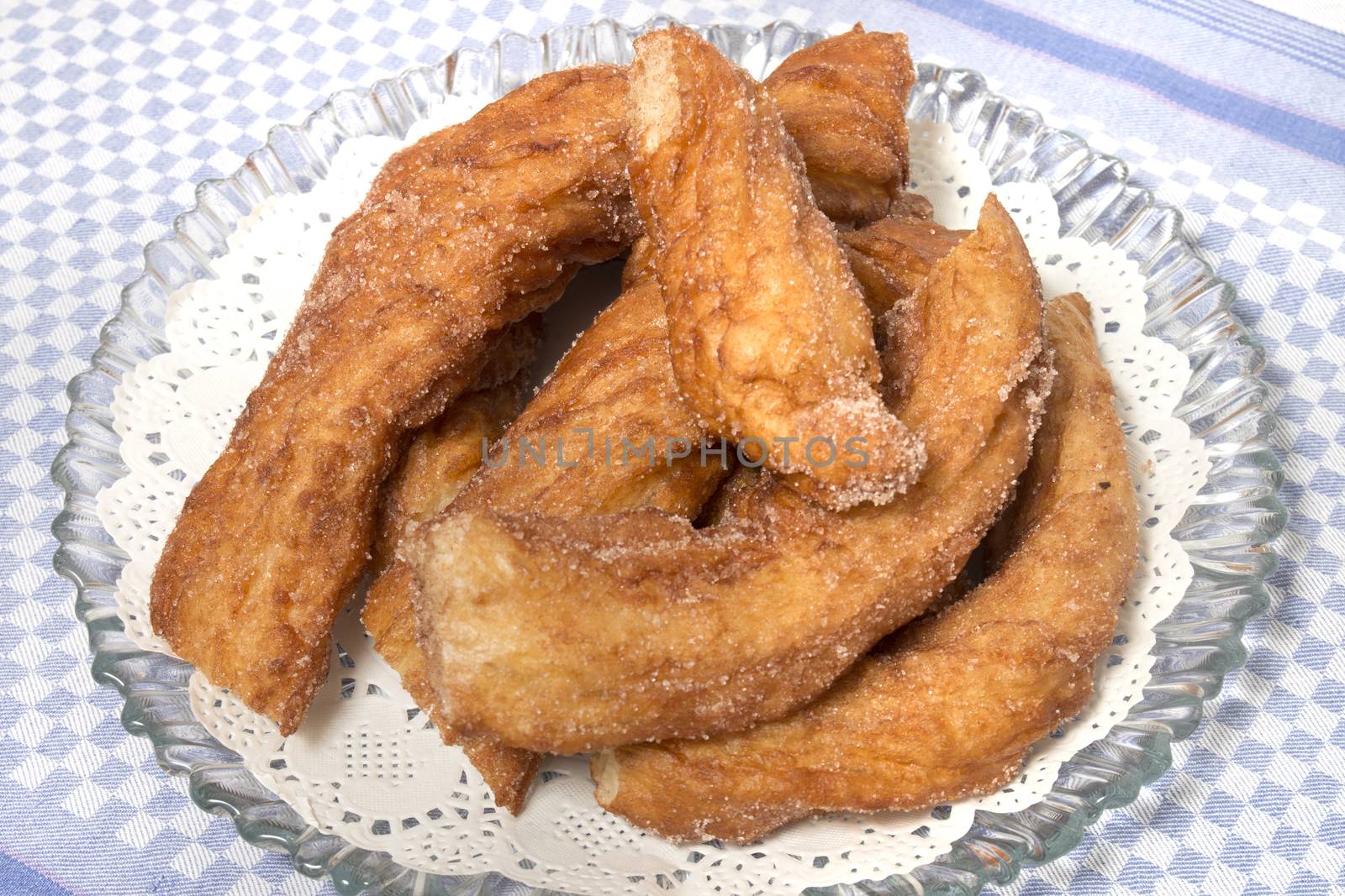 Portuguese Farturas or Spanish Churros, Fried dough sticks on a table cloth.