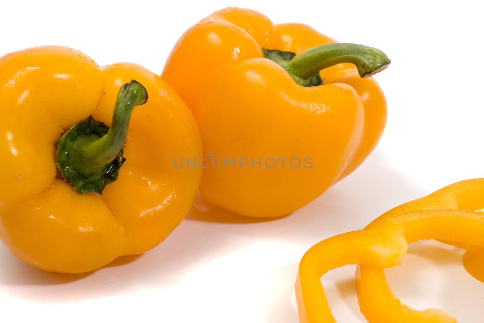 yellow bell peppers isolated on a white background.