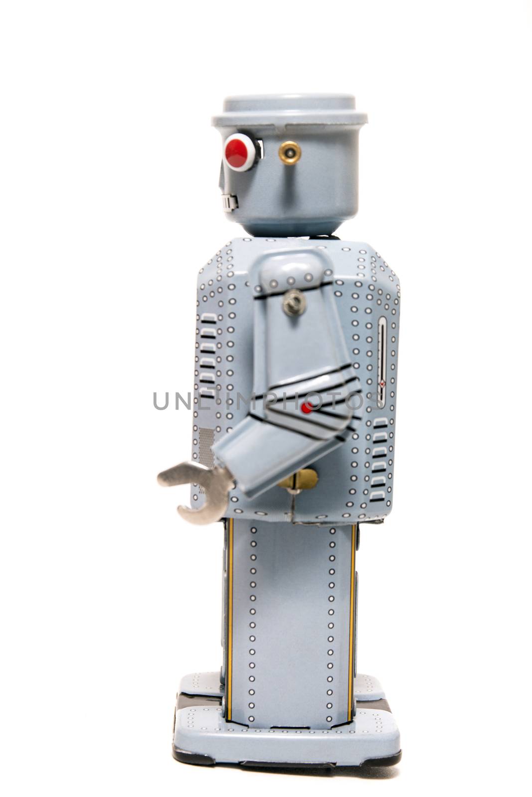 Vintage tin robot toy isolated on a white background.