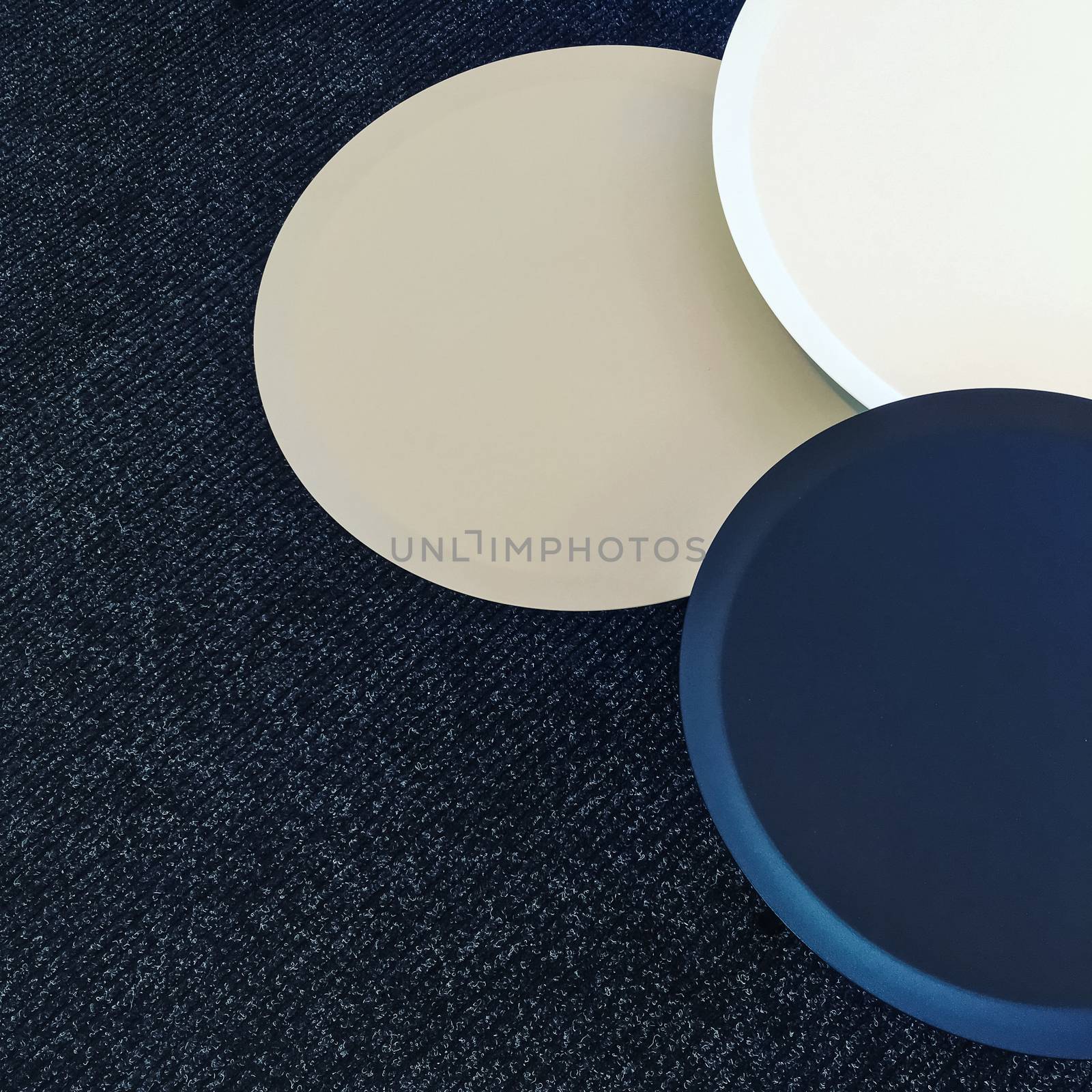 Set of round tables on a carpet floor. Modern design furniture.