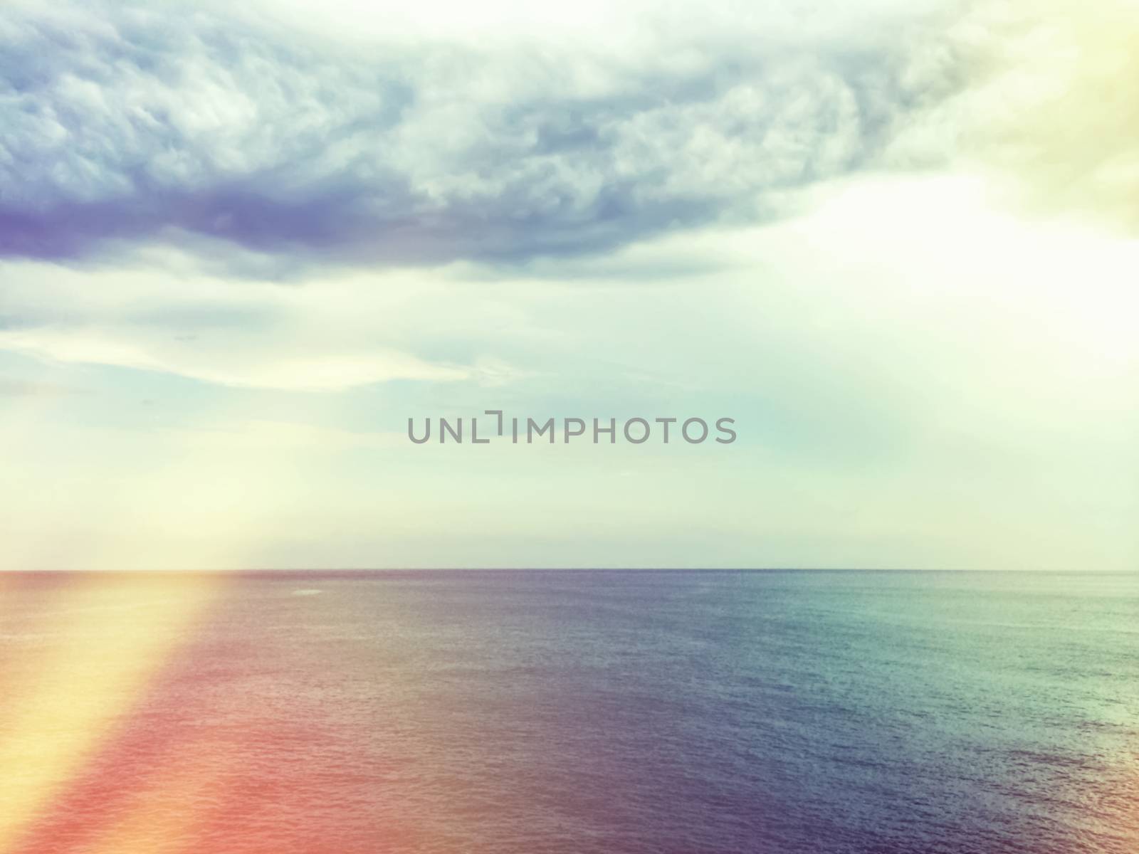 Retro style image of sea and clouds. Light leaks effect.