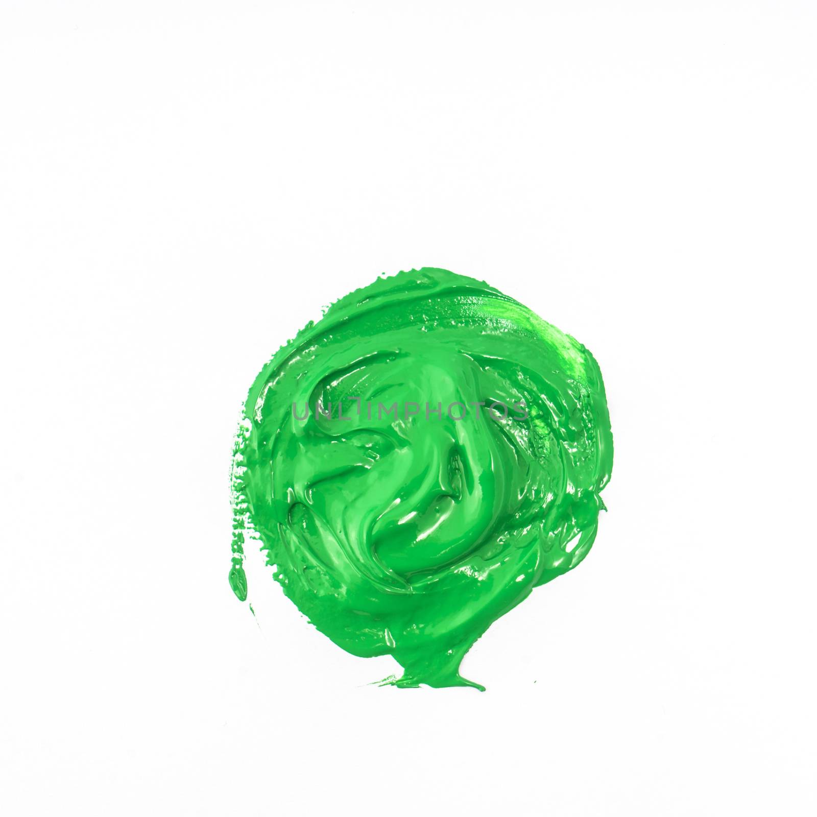 a drop of acrylic green color on a white surface