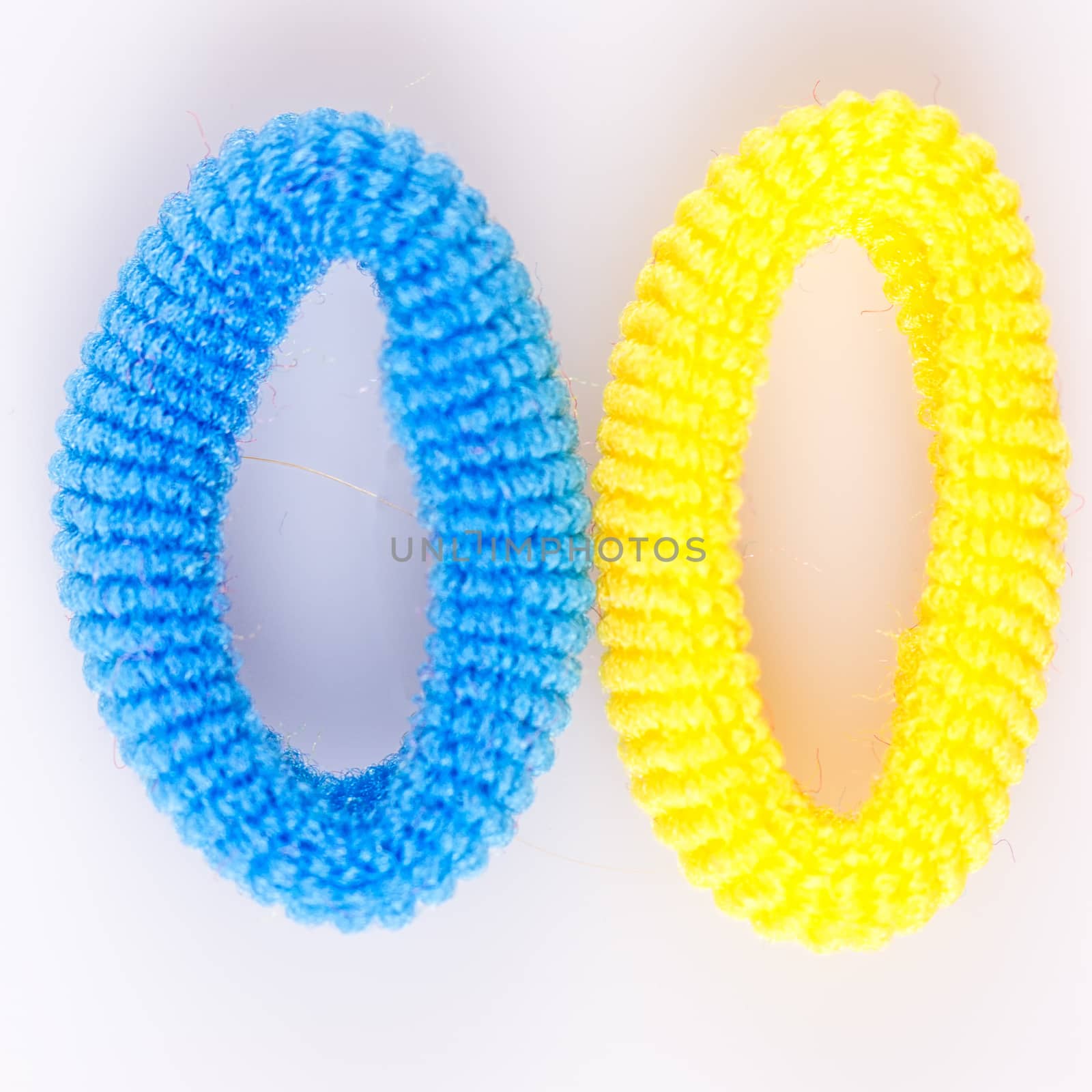 Yellow and blue soft hair bands on a white background