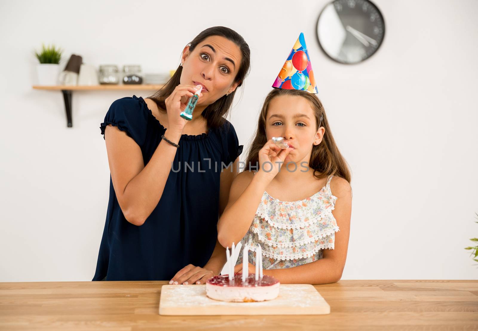 Shot of a mother and daughter in the kitchen celebrating Daughter's birthday