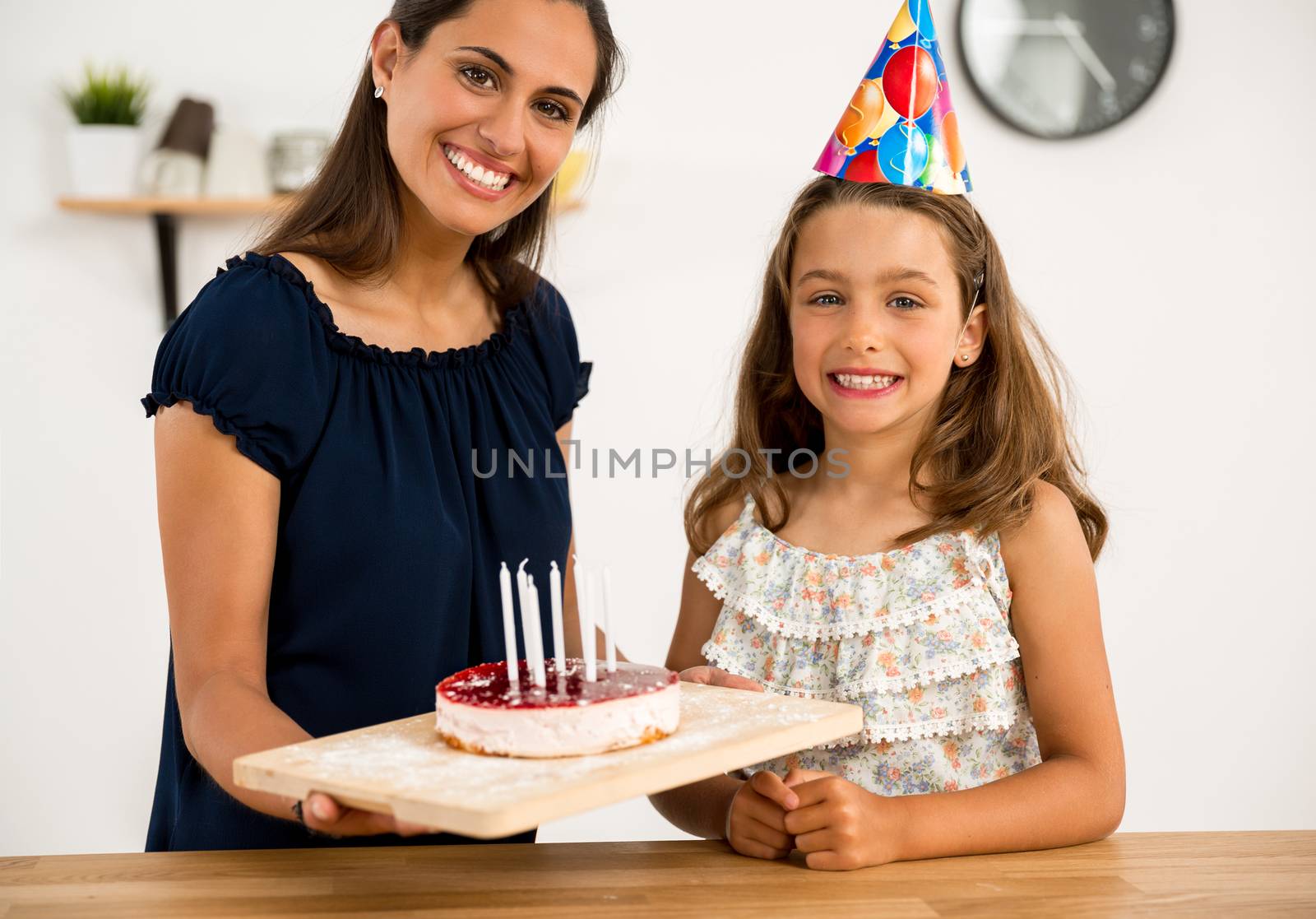 Shot of a mother and daughter in the kitchen celebrating Daughter's birthday