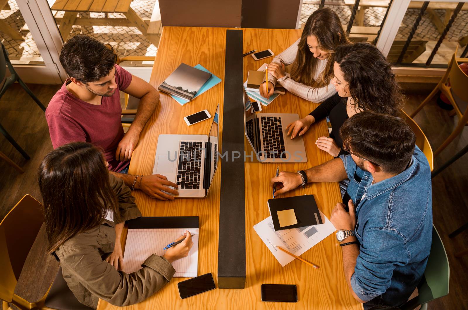 Groups of friends studying together on the bibliotech