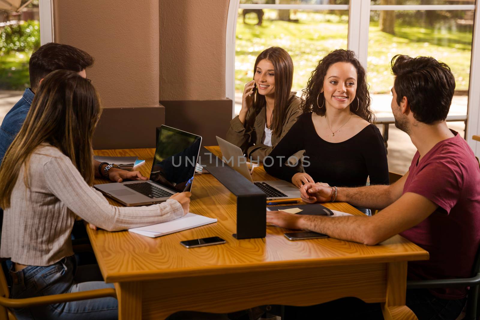 Groups of friends studying together on the bibliotech