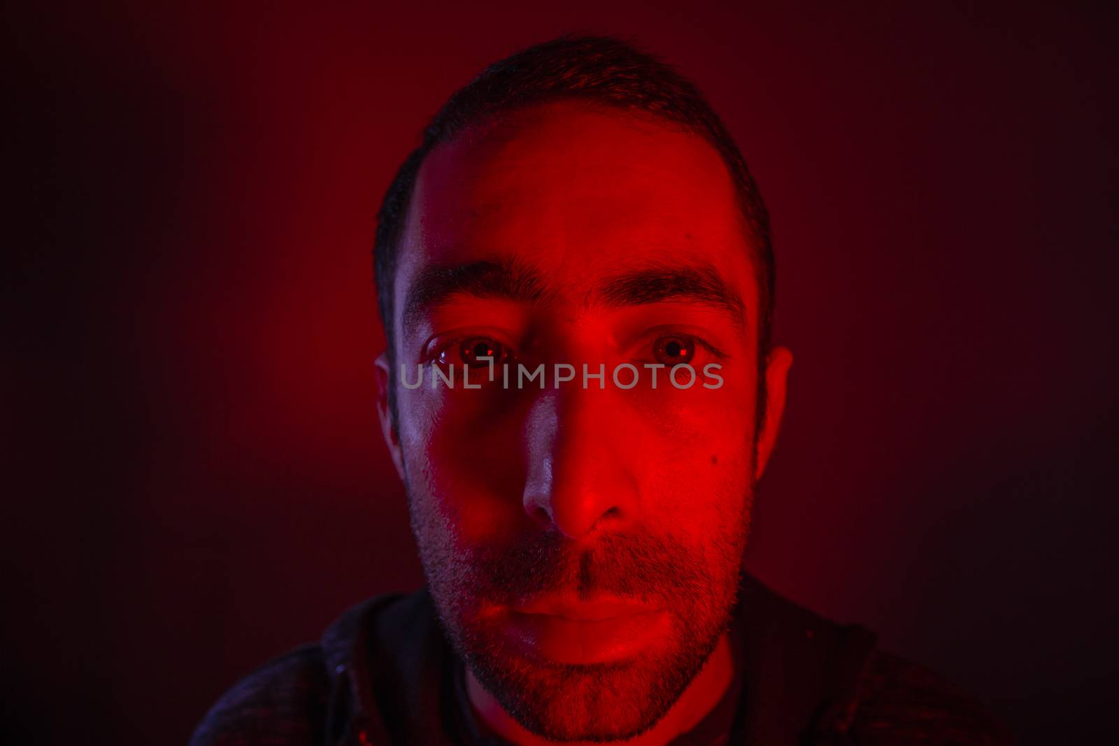 Man with serious facial expression. Close up portrait of expressionless young man.