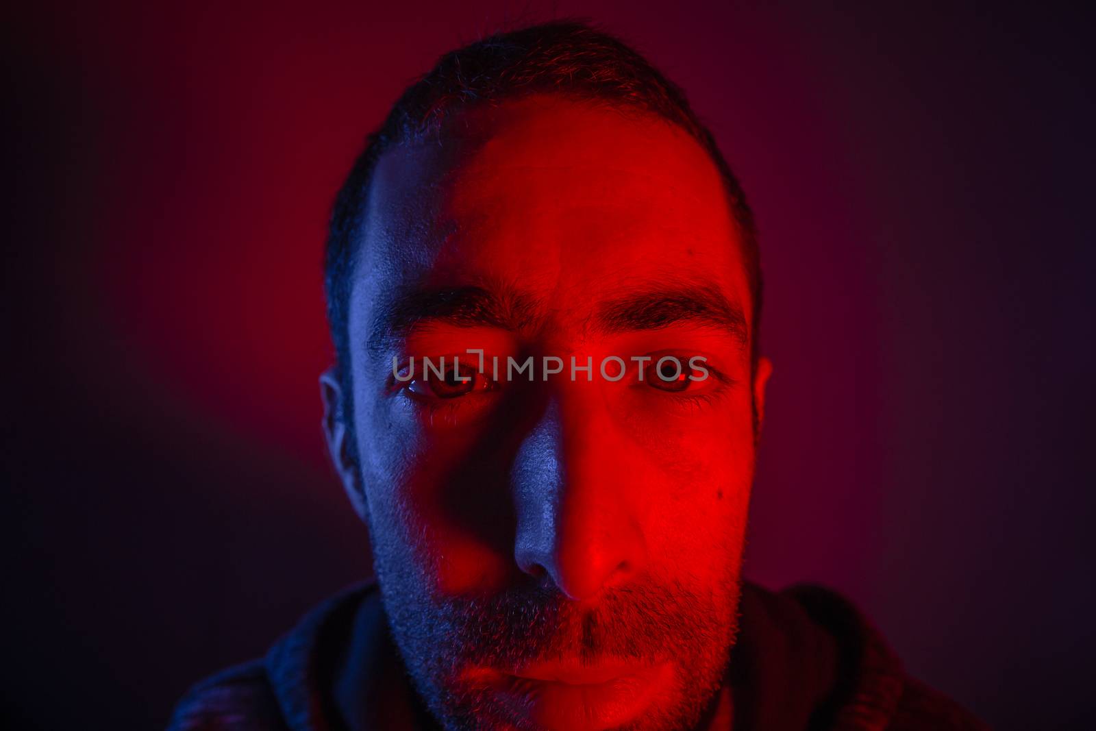 Man with serious facial expression. Close up portrait of expressionless young man.