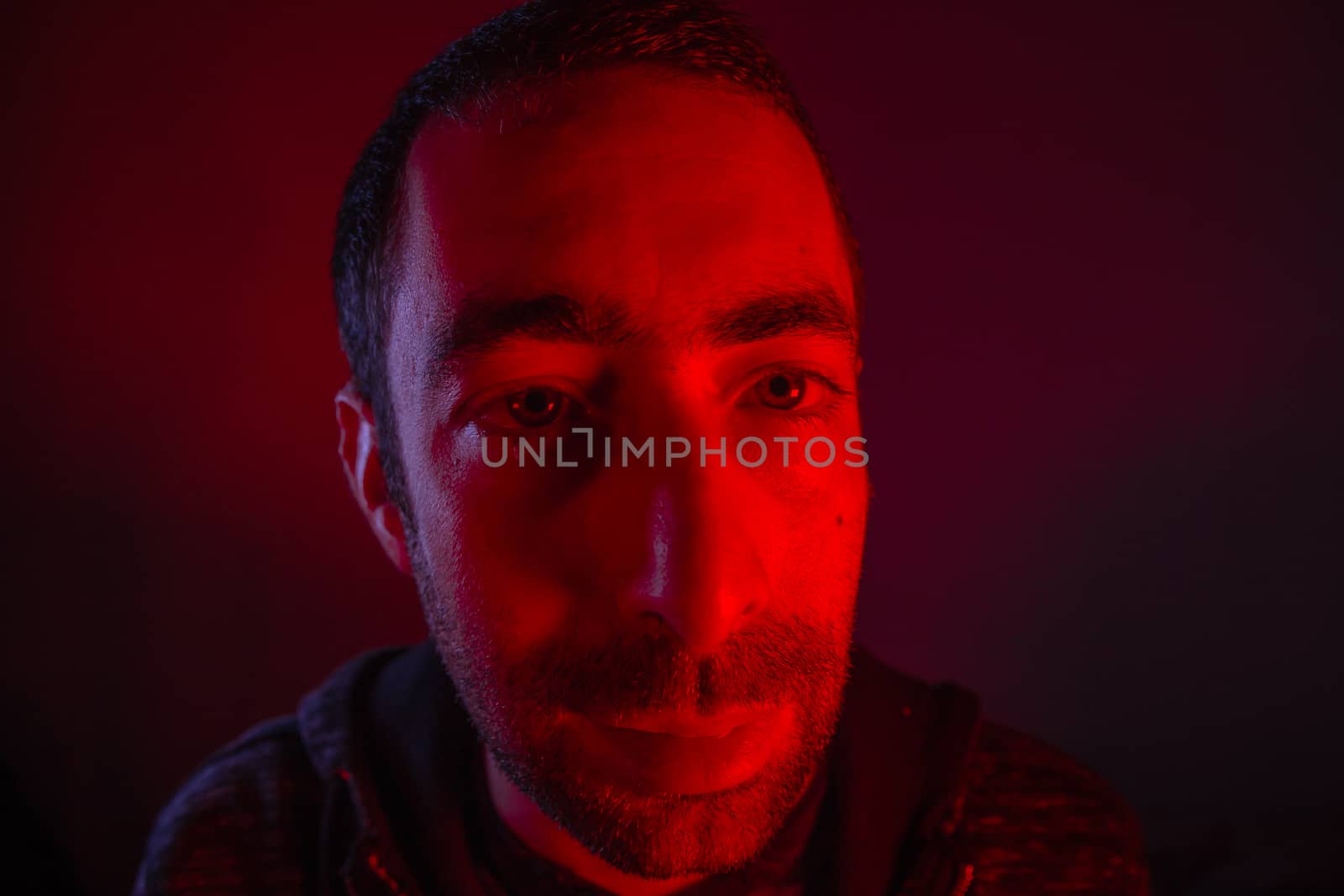 Man with happy smiling facial expression. Close up portrait of happy young man looking at camera.