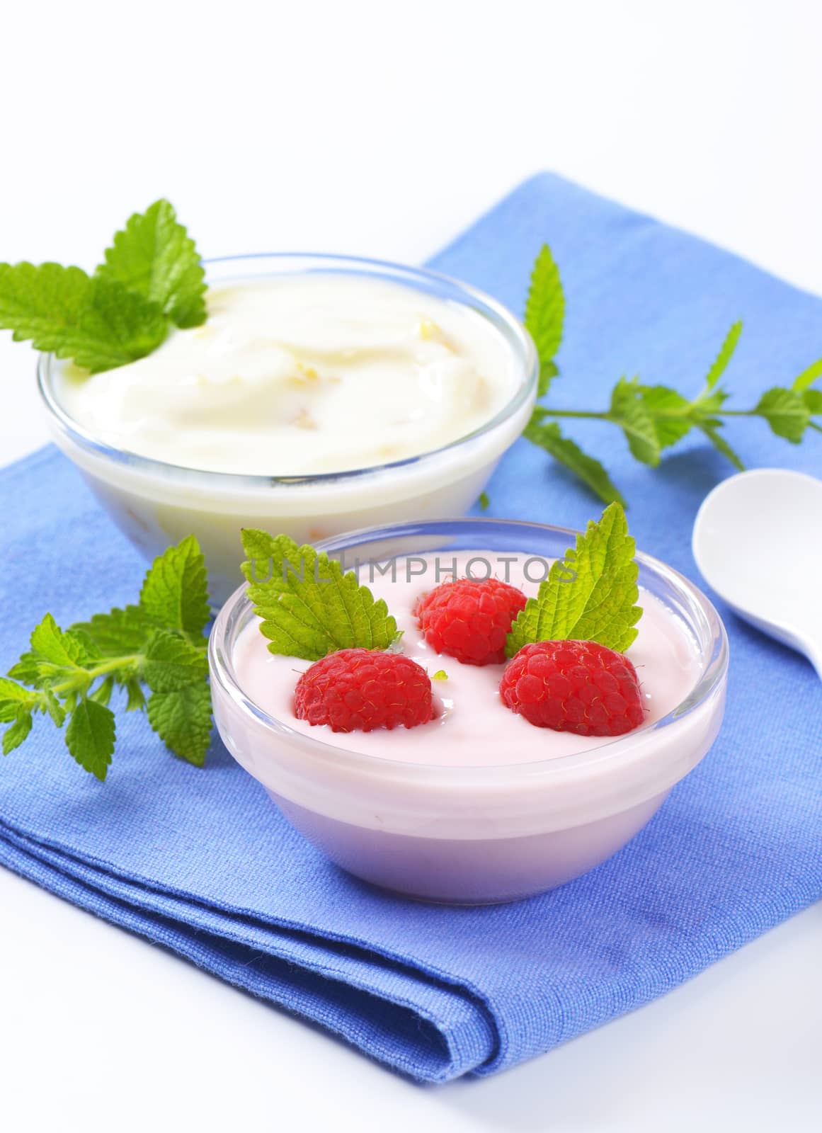 bowls of fruit yogurt on blue napkin