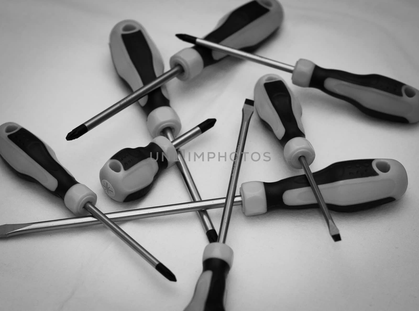 Black and white image with a wide variety of screwdrivers.