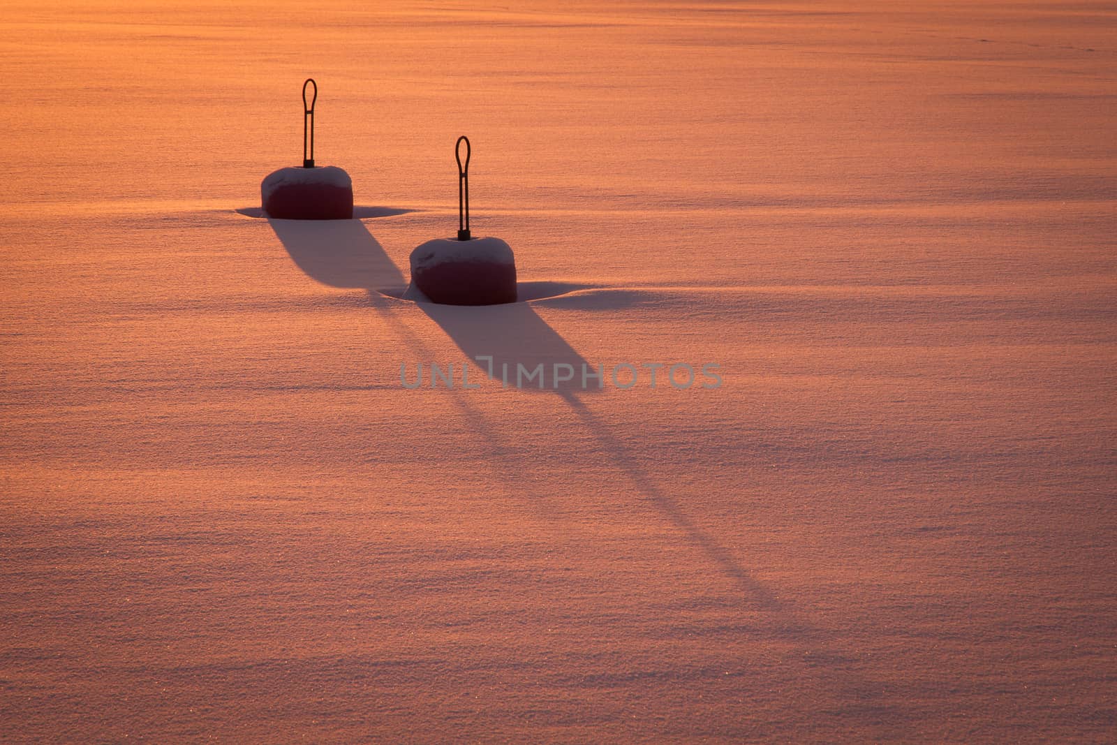 Winter image with two buoys in the frozen ocean.