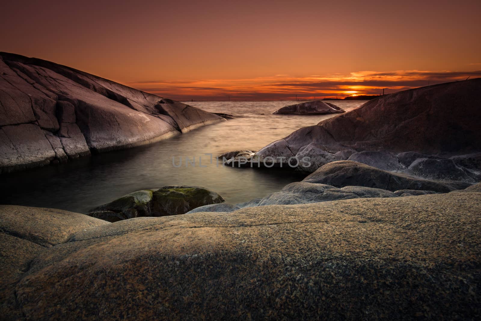 Beautiful seascape picture from Pori, Finland. Lot of rocks and orange sky.