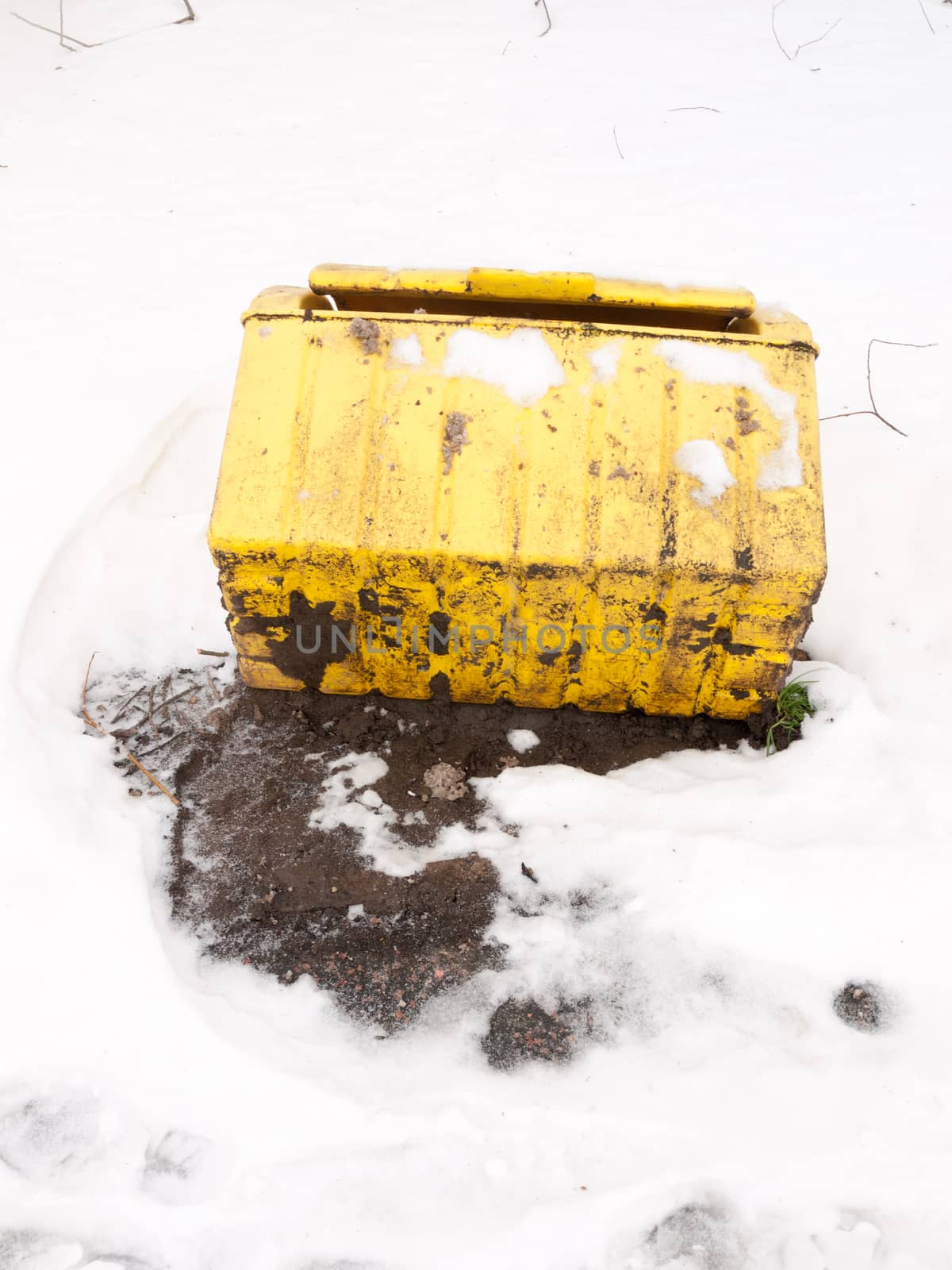 fallen turned over yellow grit box salt outside snow storm; essex; england; uk