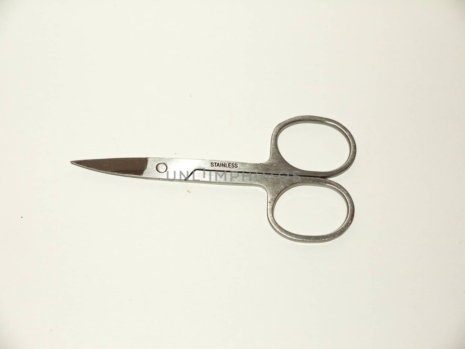 pair of silver closed nail scissors sharp white background studio; essex; england; uk