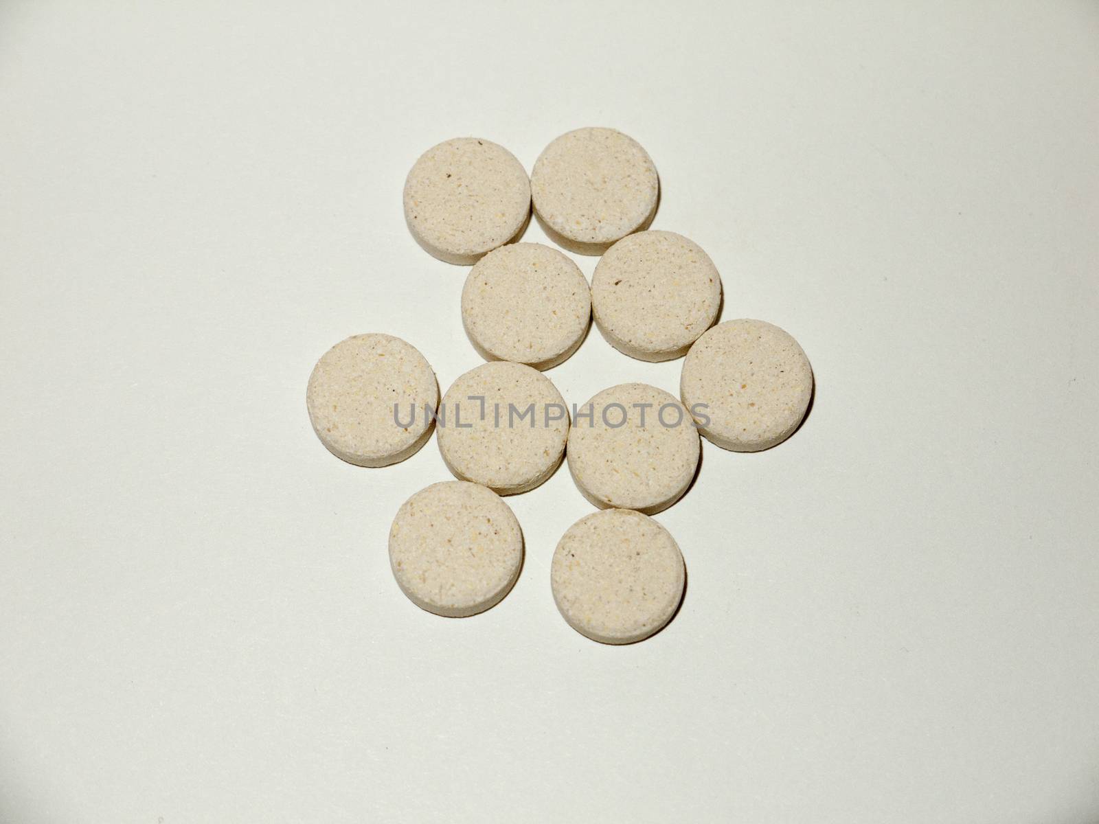 white pale circle tablets pills group of white background studio; essex; england; uk