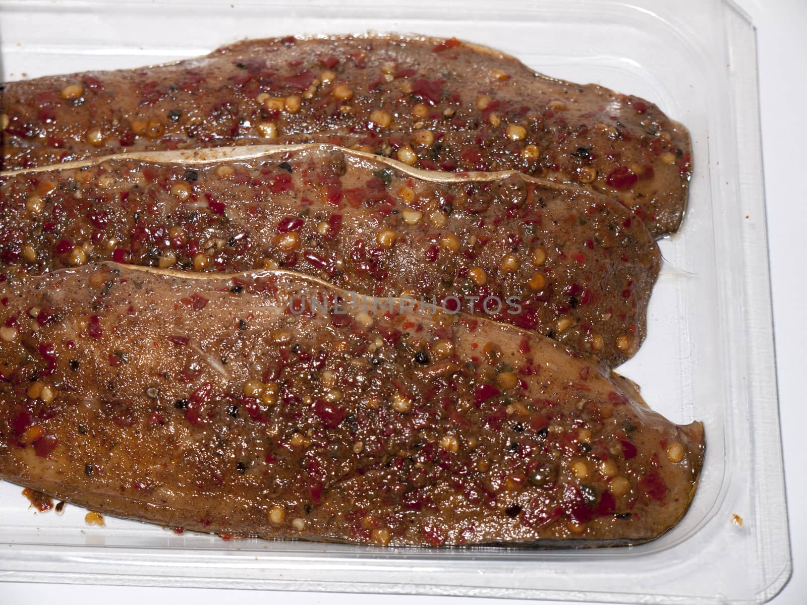 close up of peppered mackerel steaks packaged white background food; essex; england; uk