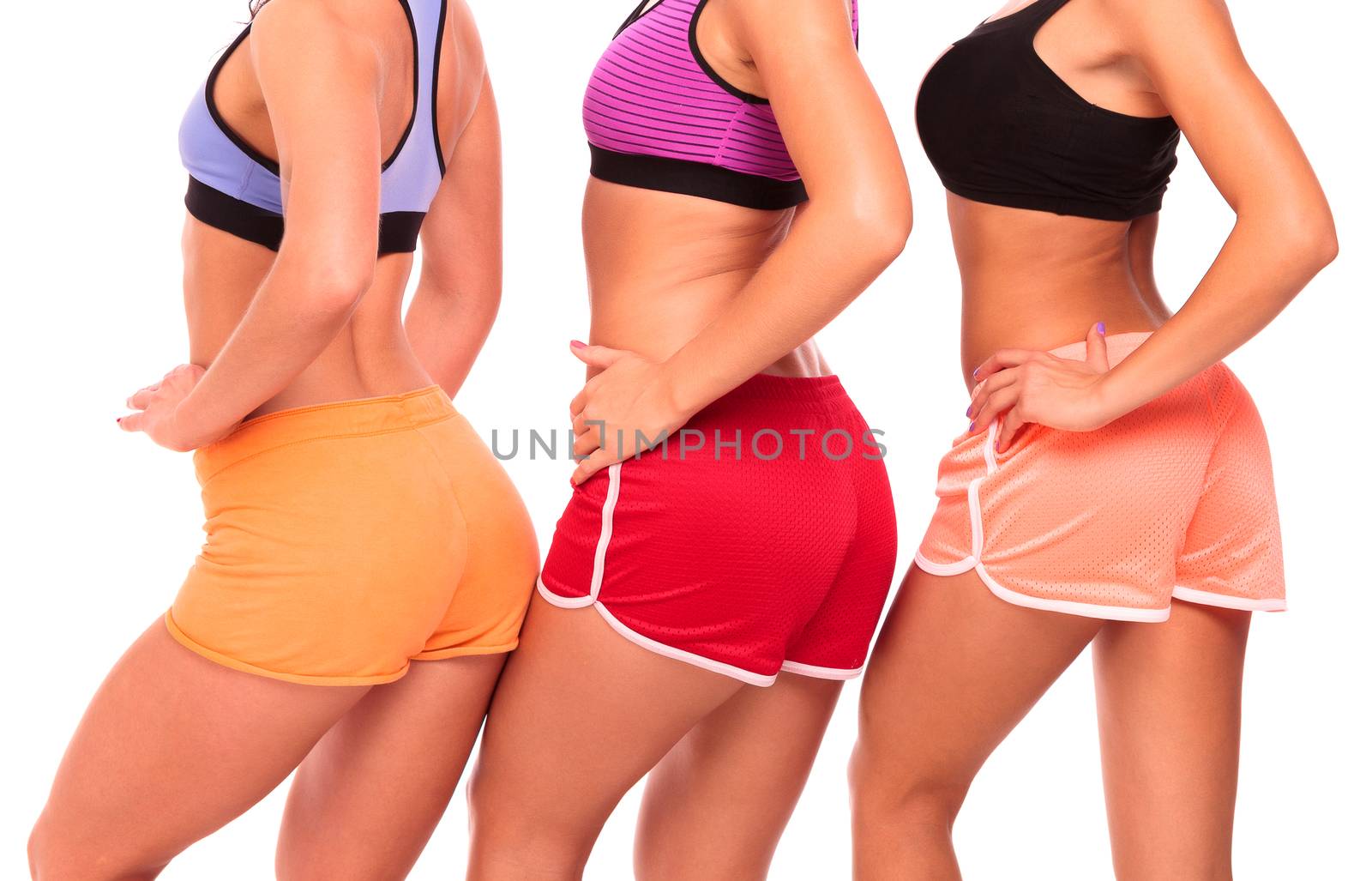 Three fit girls posing against white background, isolated by Nobilior