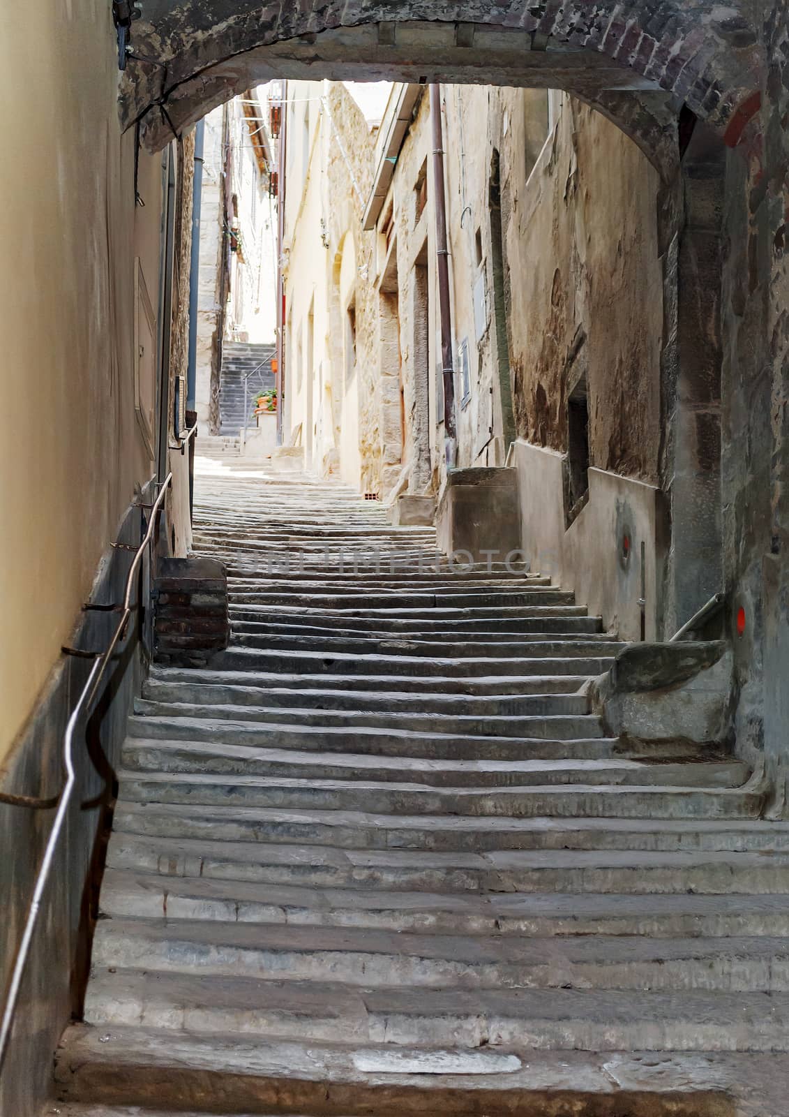 ancient staircase with an arch in the center of Cortona in Tuscany, Italy