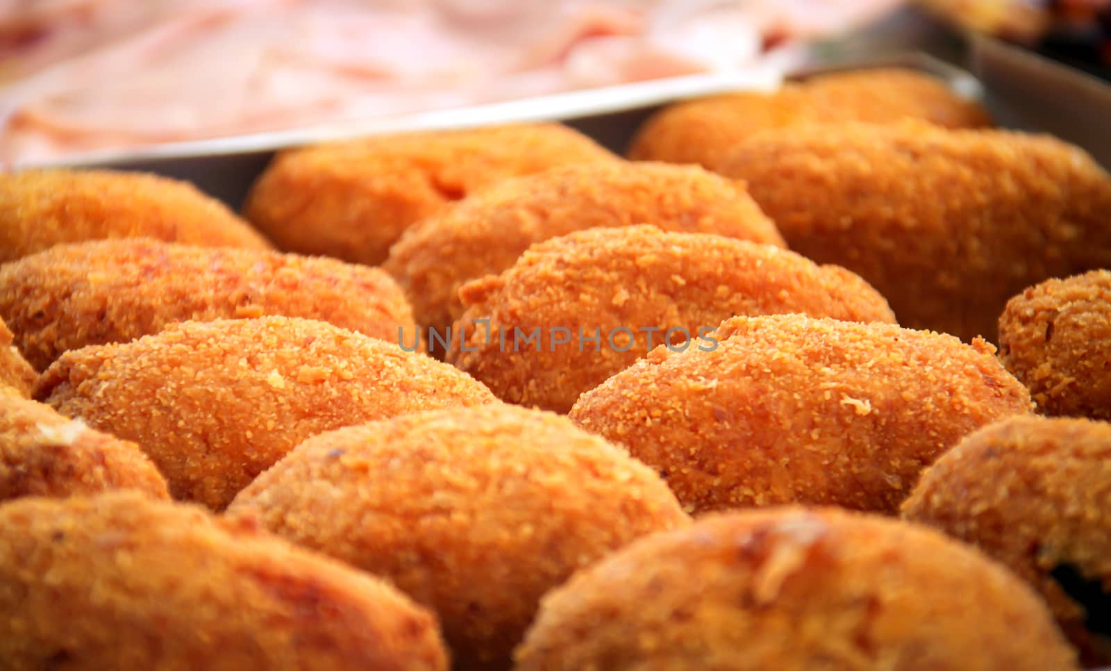 close-up view of a group of fried rice balls (Sicilian arancini)