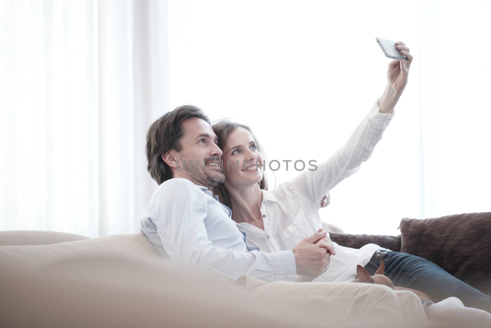 Happy couple taking selfie  by ALotOfPeople