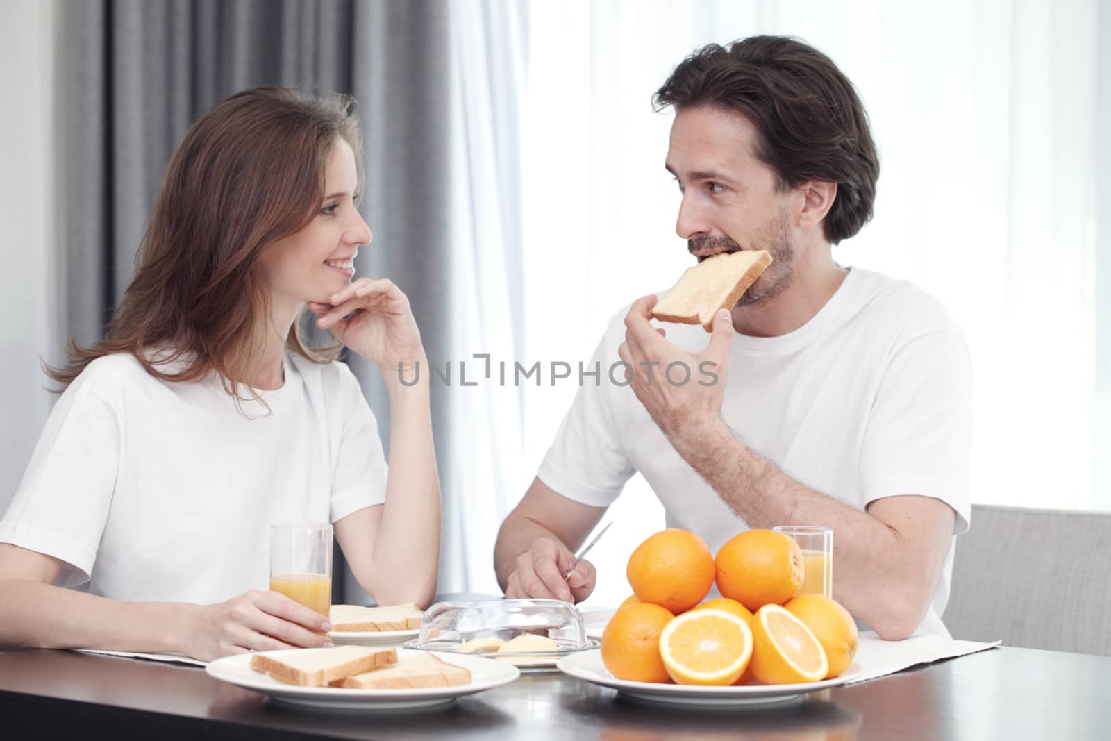 Couple having breakfast together at home 