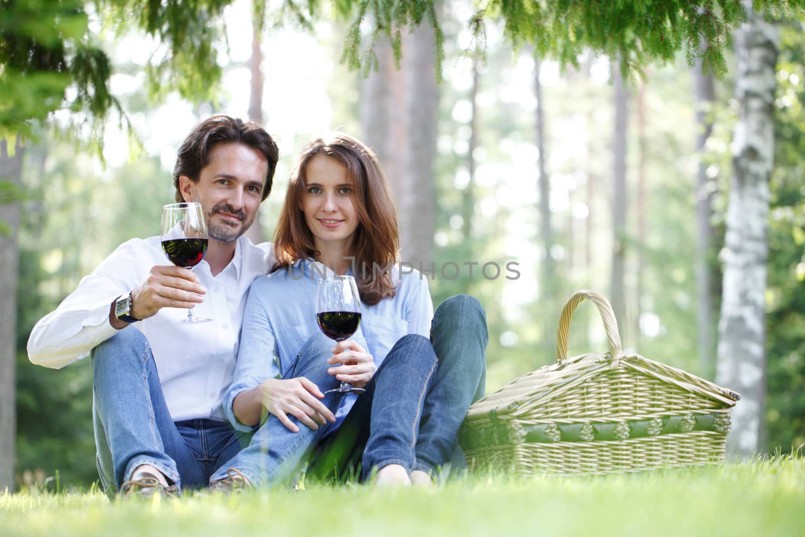 Young beautiful couple on picnic in summer park