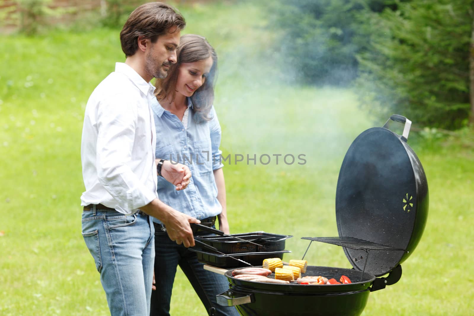 Couple cooking on barbecue  by ALotOfPeople