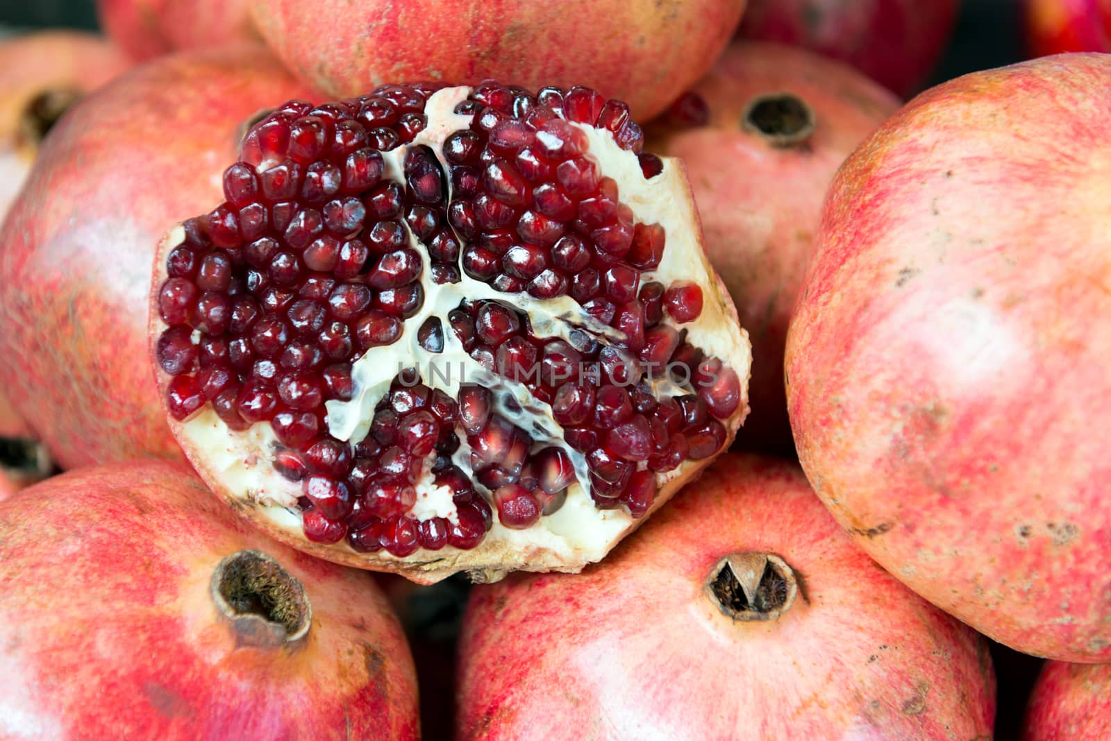 Ripe fresh pomegranate fruit on sales in market