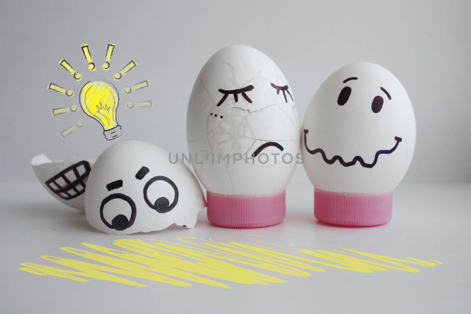 Concept of idea. Light. Eggs cheerful with a face two on a white background on a stand the grief concept crashed. Photo for your design