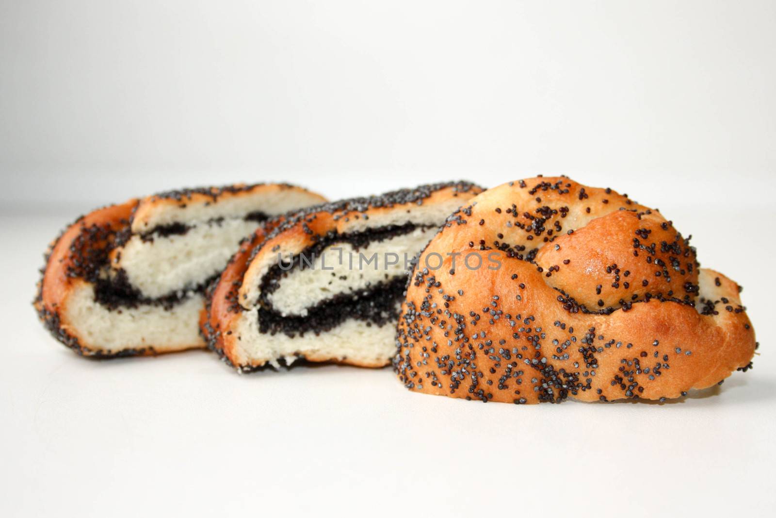 Roll with poppy seeds. An appetizing bun. Photo for your design.