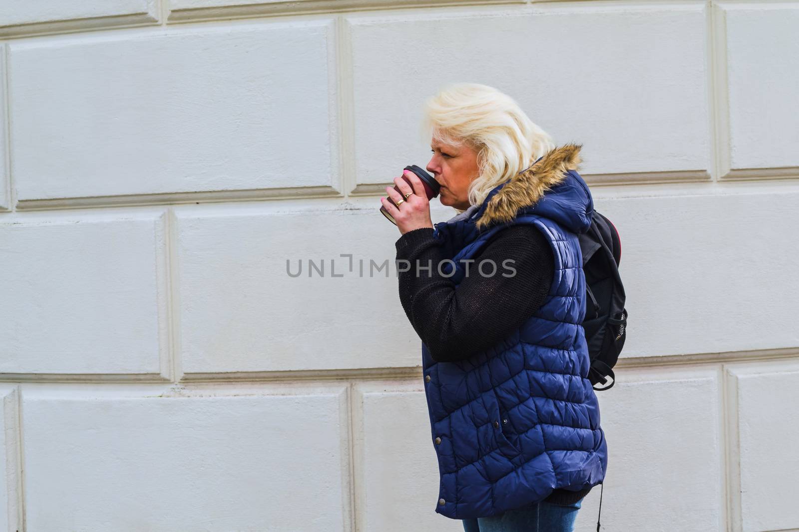 Blonde woman with a coffee to go.      by JFsPic