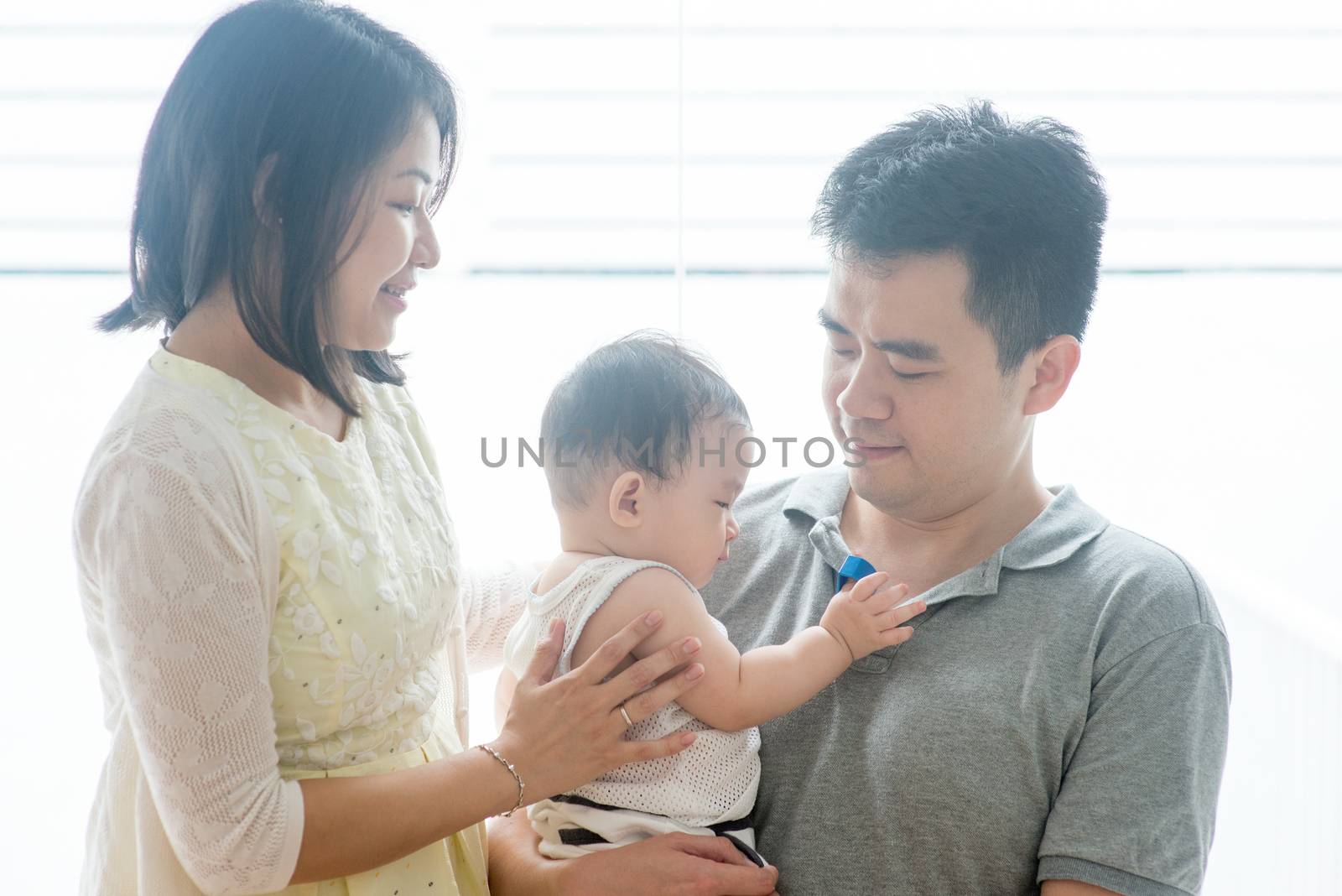 Parents and baby. Happy Asian family spending quality time at home, natural living lifestyle indoors.