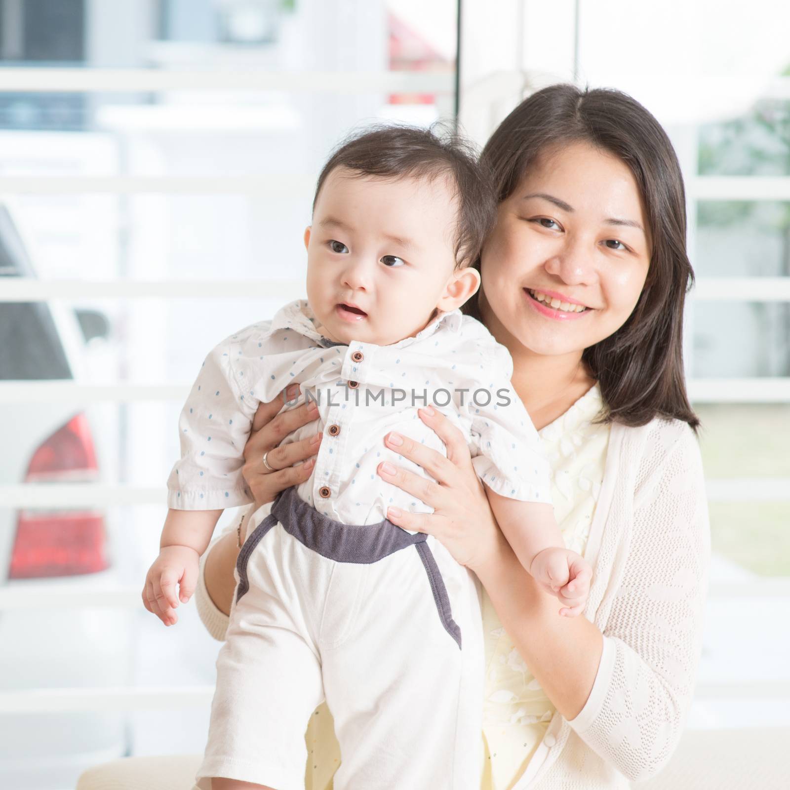 Asian family at home. Mother and 9 months old son, living lifestyle indoors.