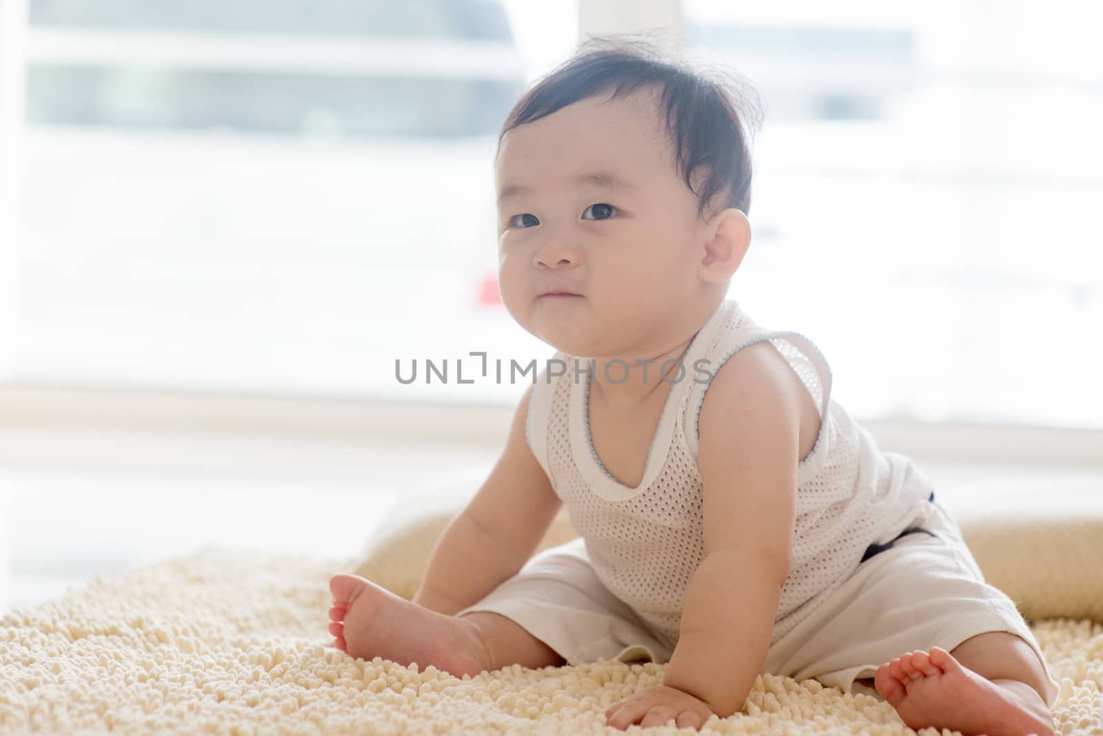 Baby boy sitting on carpet. by szefei