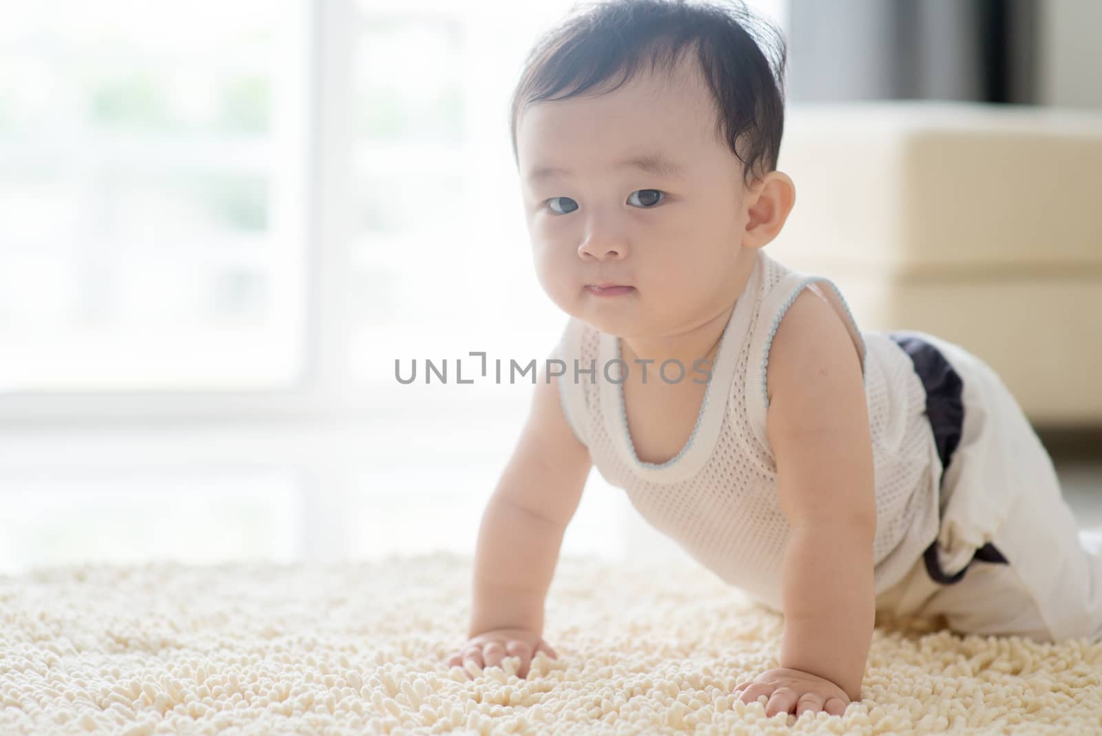 Chinese baby boy crawling on carpet. by szefei