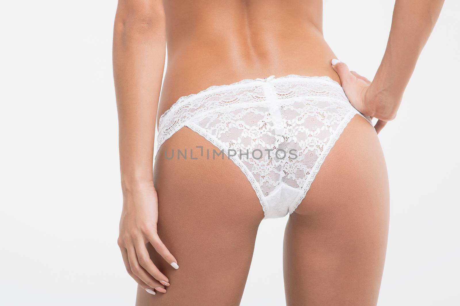 Perfect body young woman on a white background in sexy lingerie