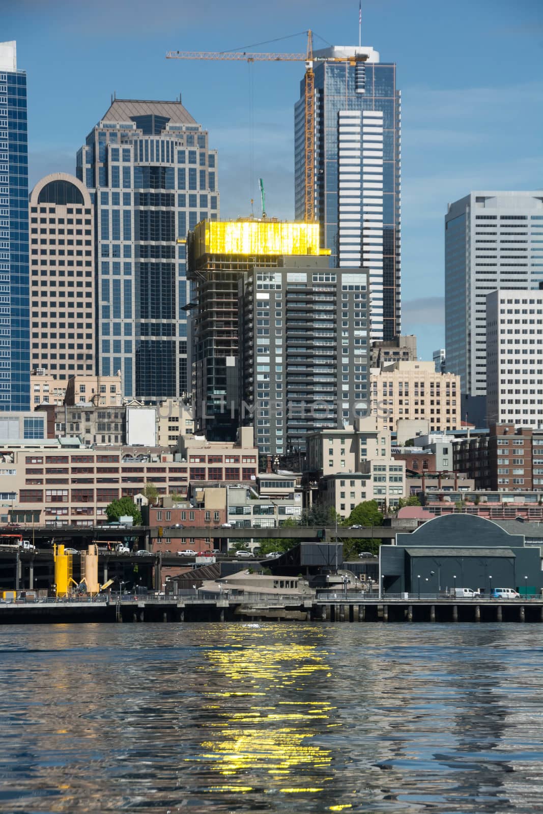 New construction yields golden reflections on the still waters of Seattle's Elliott Bay