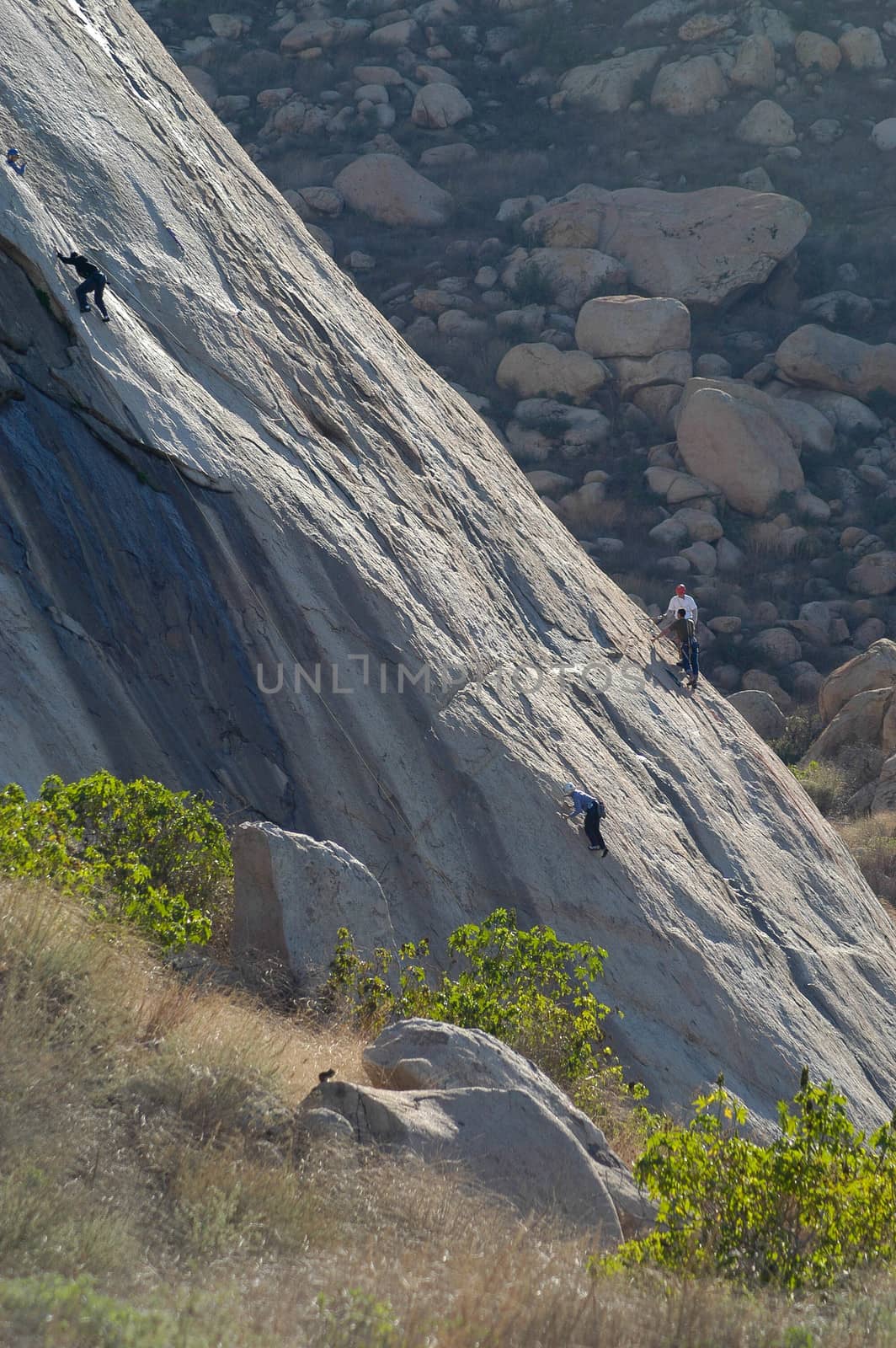 Rock Climbers scale rocks at Lake Perris, CA