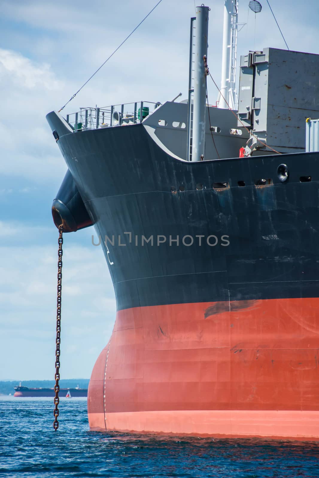 View of bow of cargo ship with anchor chain deployed