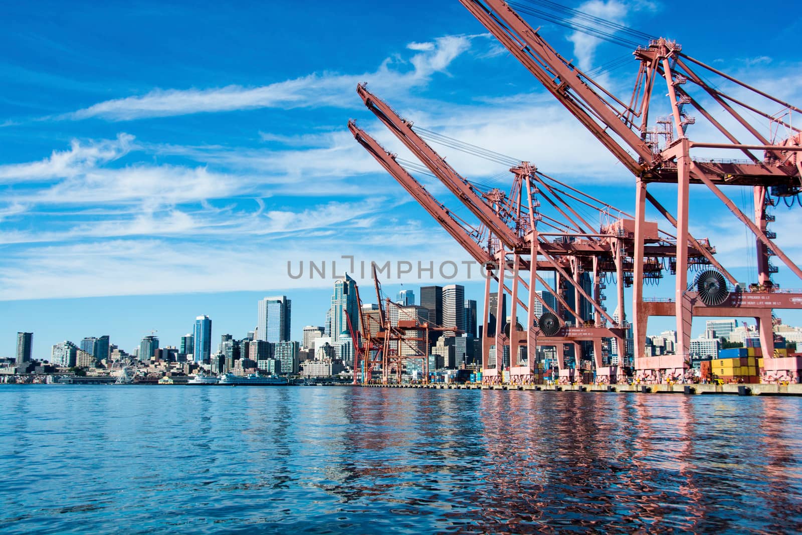 Downtown Seattle framed by container cranes.