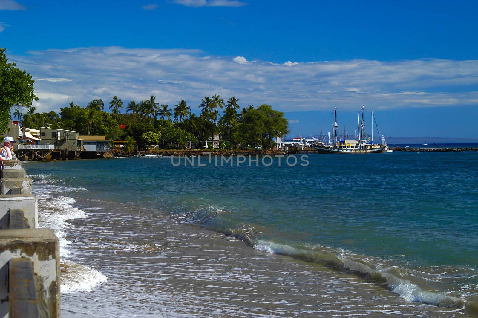 Gentle waves break on white sand beach in Lahaina, Maui, HI