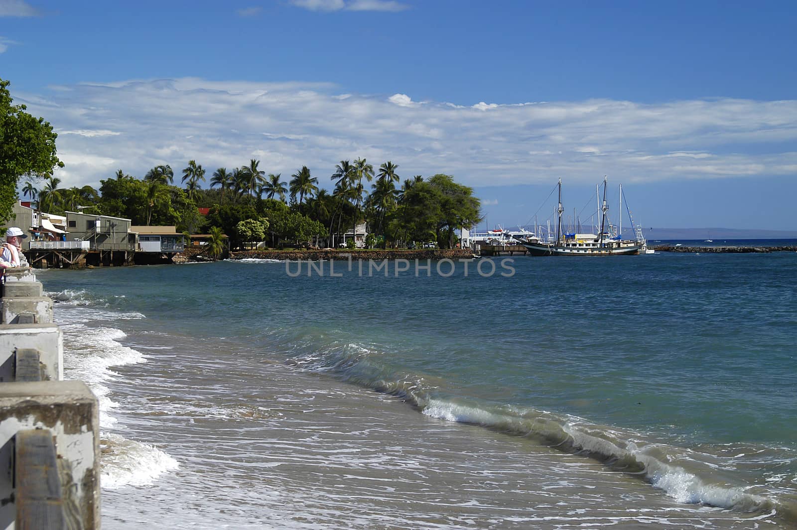 Gentle waves break on white sand beach in Lahaina, Maui, HI